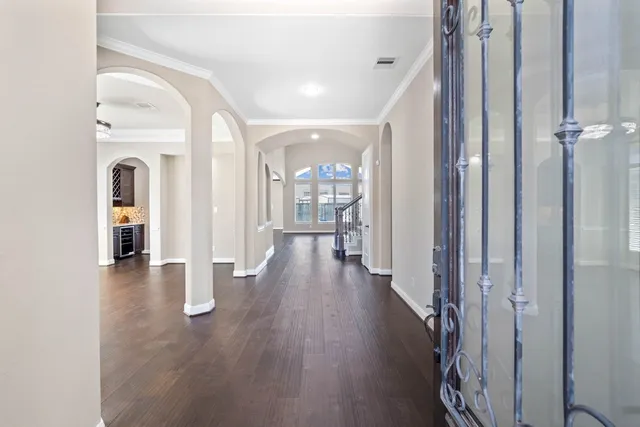 a view of a hallway with wooden floor windows and livingroom