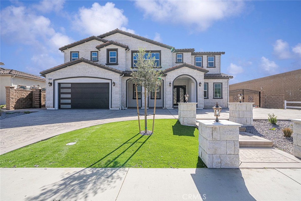 a front view of a house with yard and green space