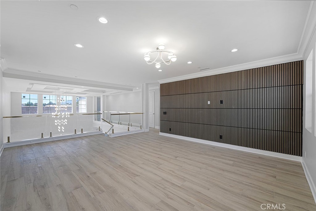 13705 Copley Drive Rancho Cucamonga, CA 91739 - Photo 11 of 13 a view of an empty room with wooden floor and a window