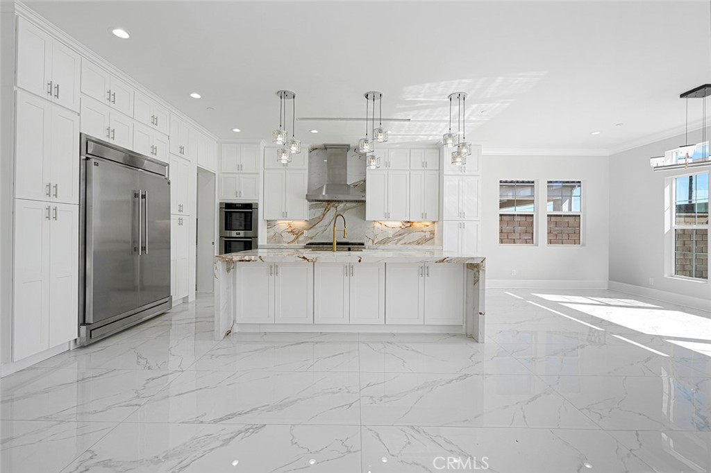 13705 Copley Drive Rancho Cucamonga, CA 91739 - Photo 6 of 13 a large white kitchen with cabinets and stainless steel appliances