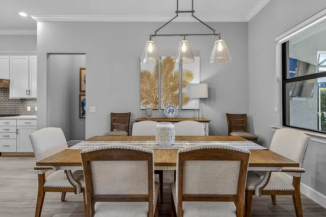 a view of a dining room with furniture and chandelier