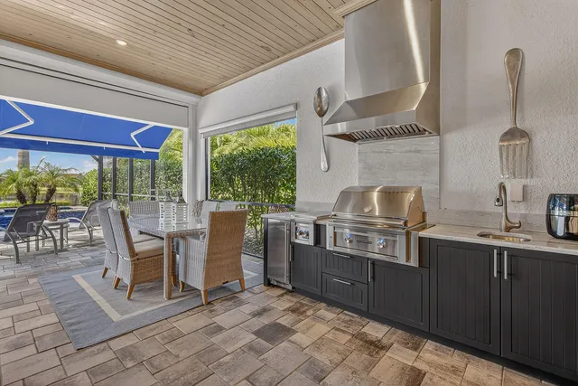 a dining room with stainless steel appliances granite countertop a stove and a sink