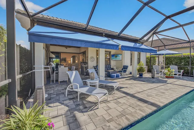a view of a patio with table and chairs and potted plants