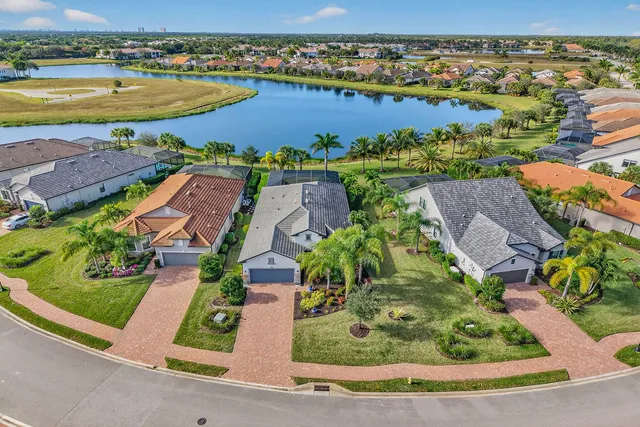 an aerial view of residential houses with outdoor space and river view