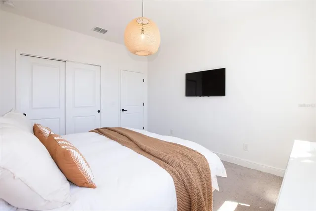 a bedroom with a bed and a flat screen tv