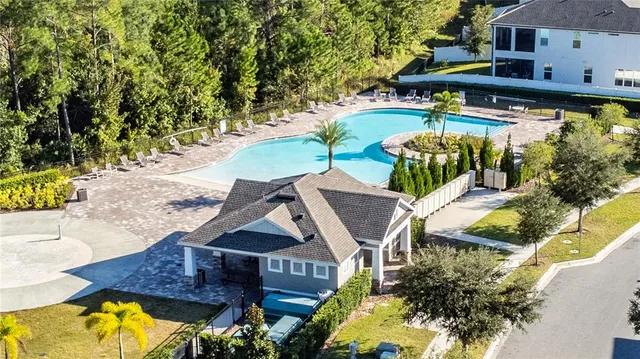 an aerial view of swimming pool with outdoor seating