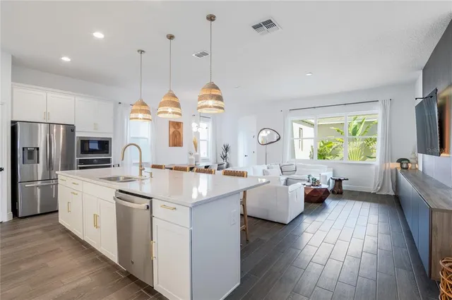 a kitchen with sink cabinets and wooden floor
