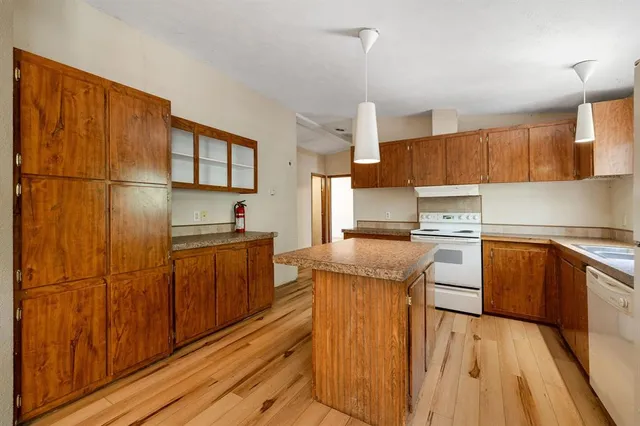 a kitchen with stainless steel appliances granite countertop a refrigerator sink and cabinets