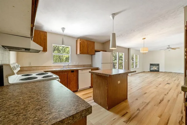 a kitchen with stainless steel appliances granite countertop wooden cabinets and a stove