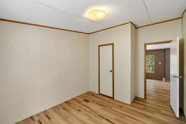 a view of a room with wooden floor