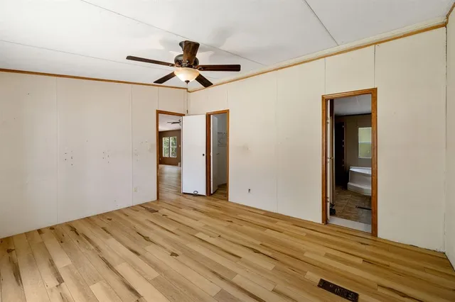 a view of a room with a ceiling fan