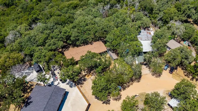 an aerial view of residential house with outdoor space and trees around