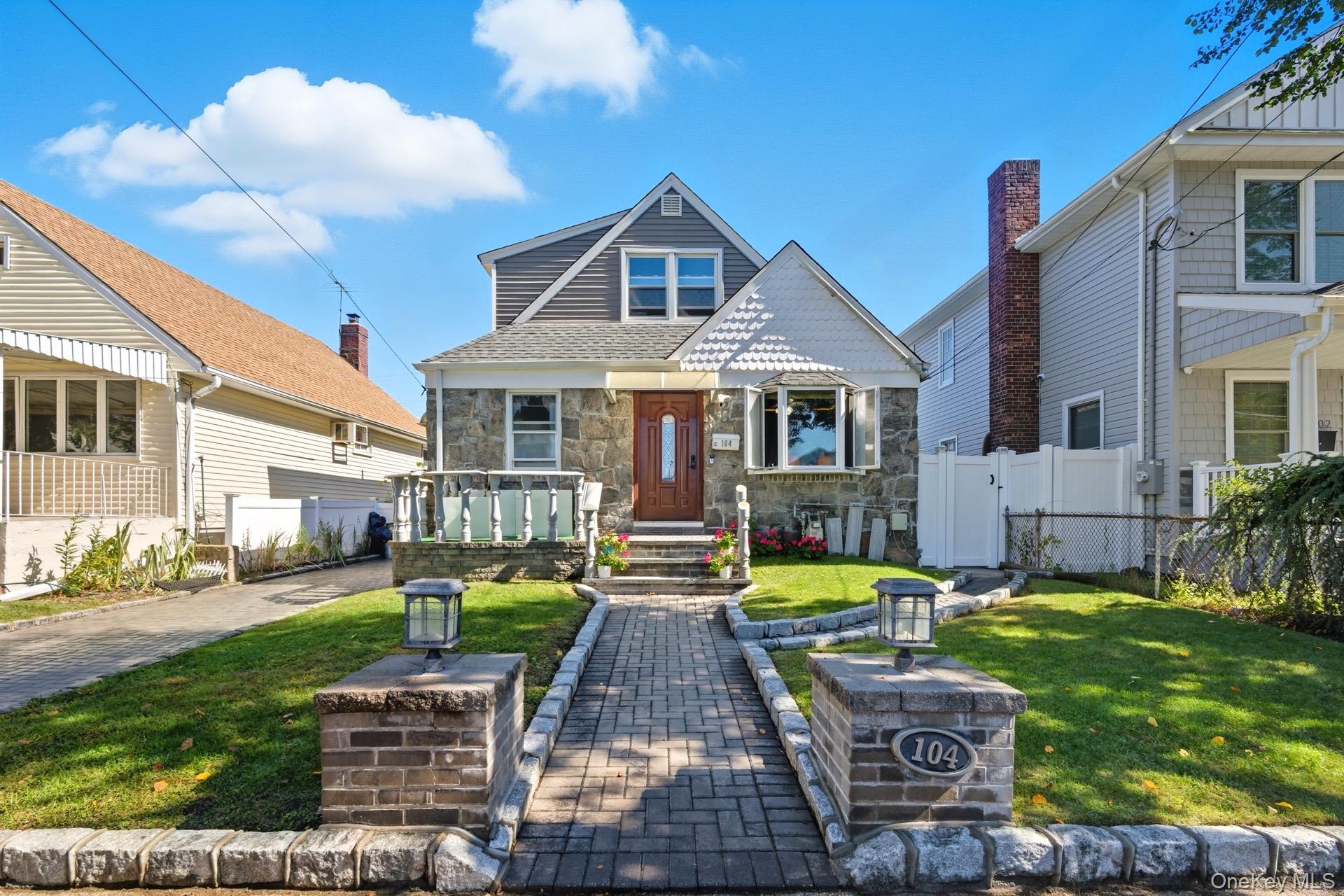 a front view of a house with garden and patio