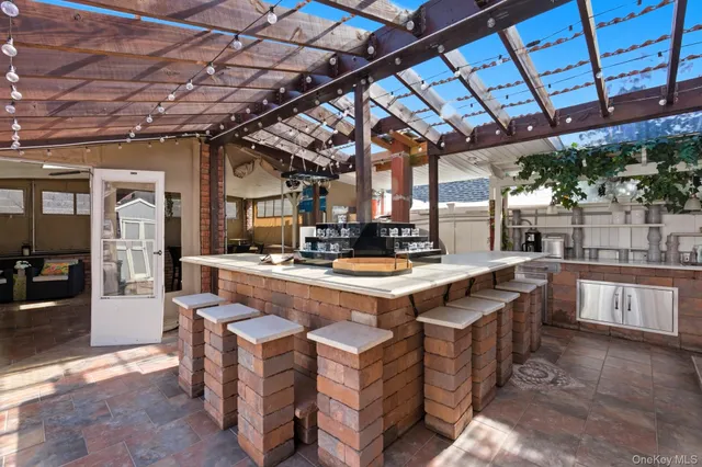 a view of a patio with table and chairs with wooden floor and fence