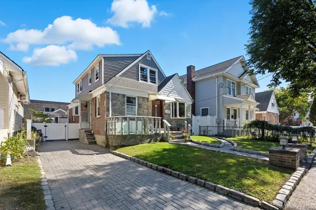 a front view of a house with a yard table and chairs
