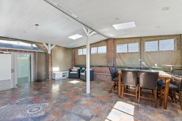 a front view of a house with outdoor seating