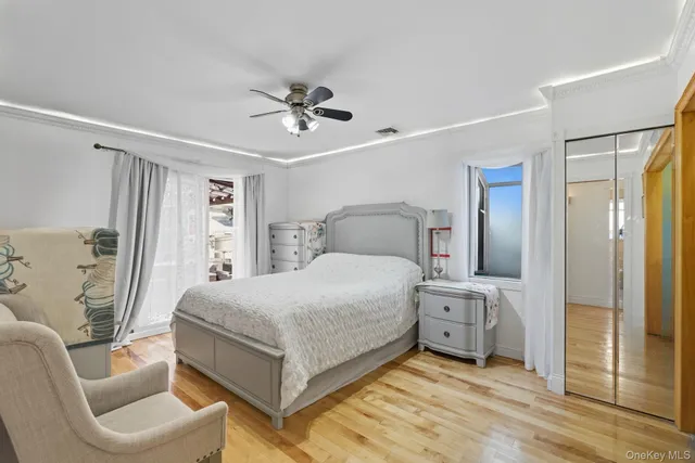 a bedroom with a bed and a mirror