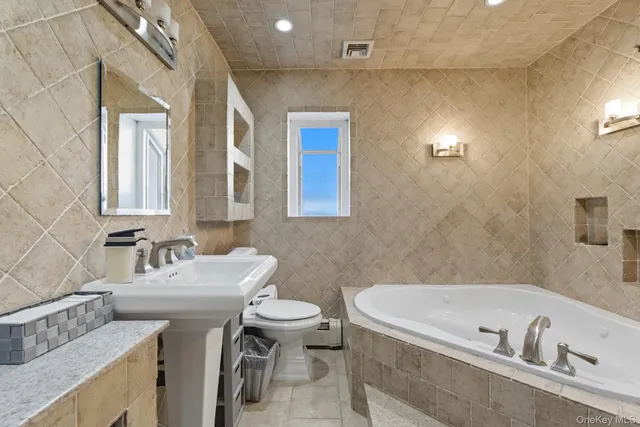 a bathroom with a tub a sink and a toilet