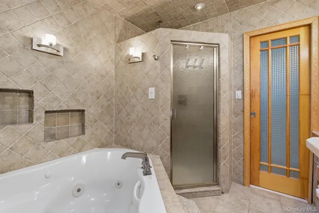 a bathroom with a tub shower and sink