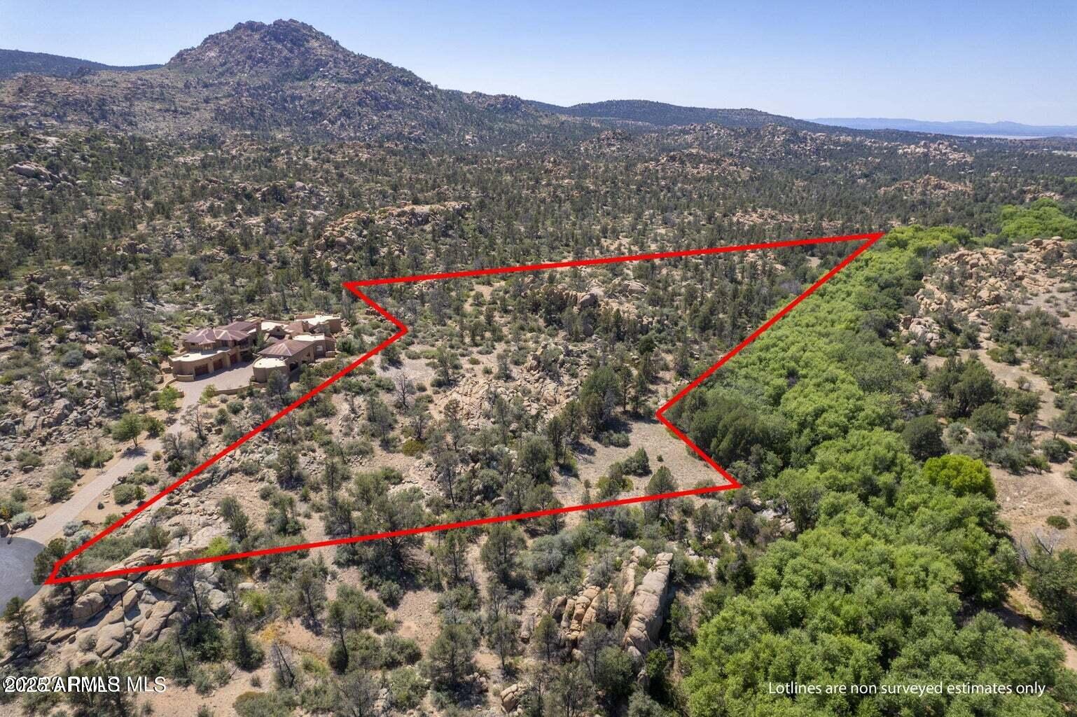 4755 Phantom Hill Road, Unit 163 Prescott, AZ 86305 - Photo 5 of 14 a view of a lush green hillside and a houses