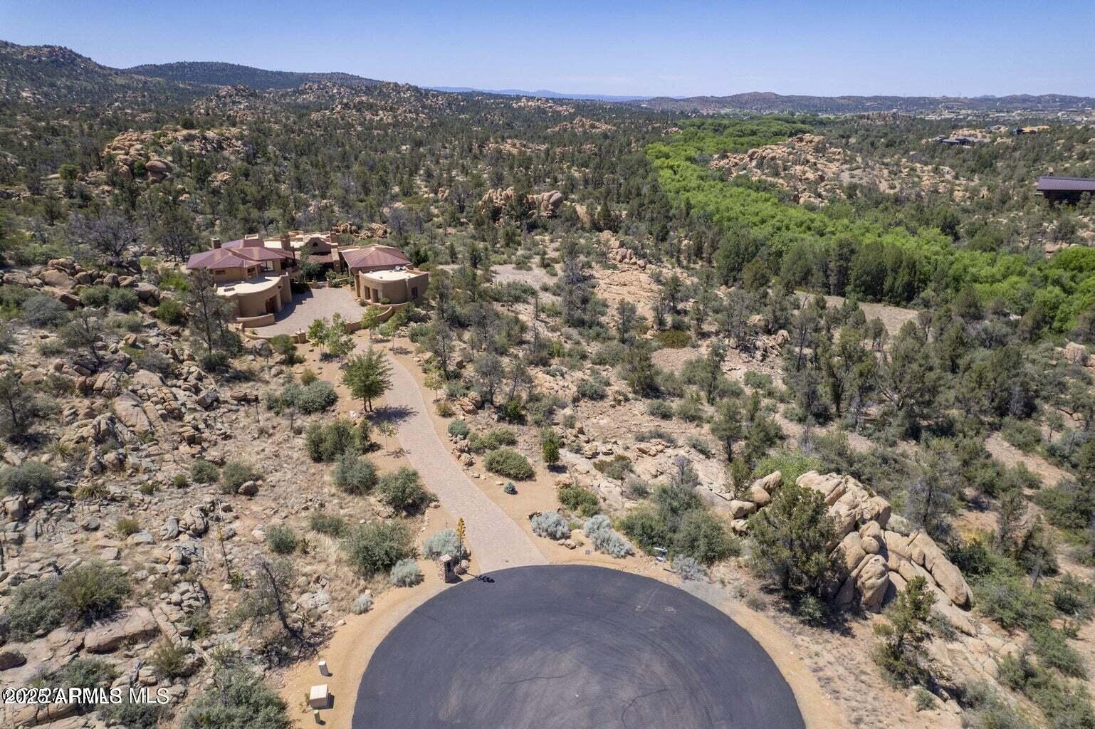 4755 Phantom Hill Road, Unit 163 Prescott, AZ 86305 - Photo 9 of 14 an aerial view of a house with a yard and mountain view in back