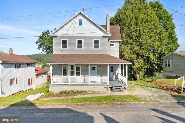 a front view of a house with a yard table and chairs