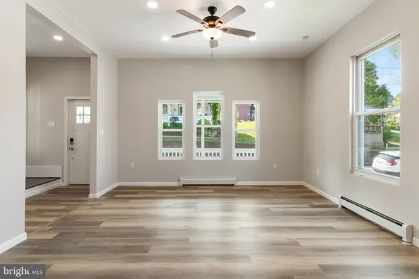 an empty room with windows and closet