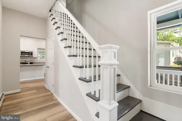 a view of entryway and hall with wooden floor