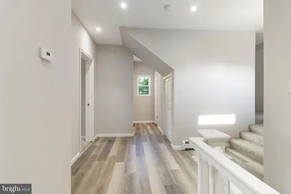 a view of a bedroom with wooden floor