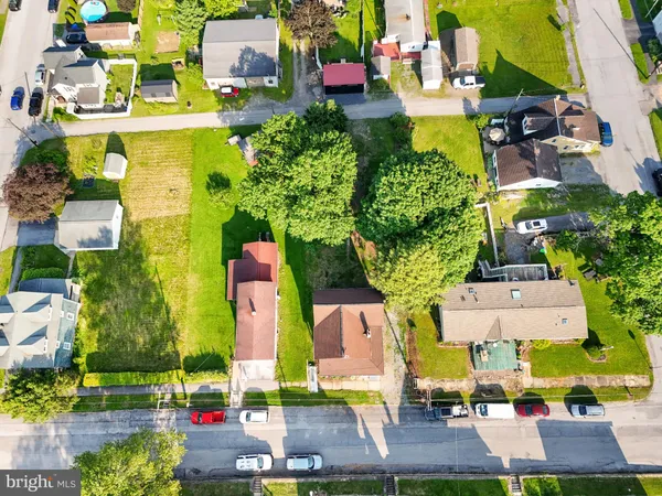 an aerial view of multiple houses with yard