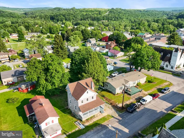 an aerial view of residential house with outdoor space and swimming pool