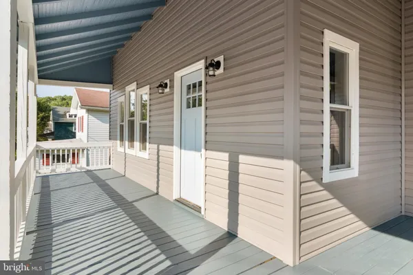 a view of a balcony with wooden floor and fence