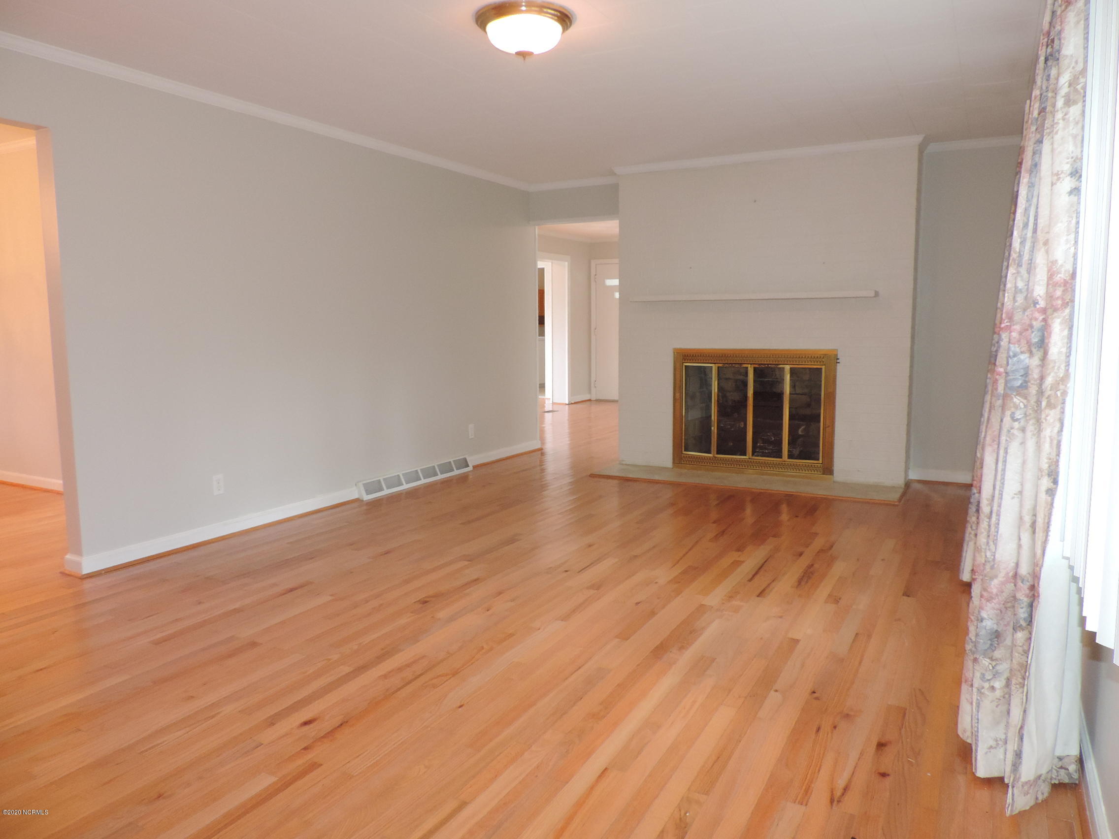 411 Flanners Beach Road New Bern, NC 28560 - Photo 5 of 44 LR with hardwood floors and fireplace