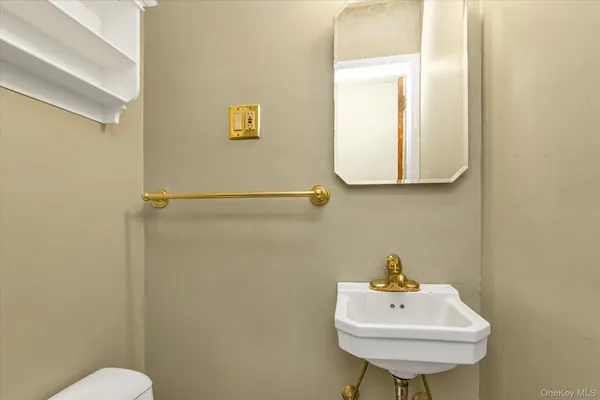 a bathroom with a sink mirror and toilet
