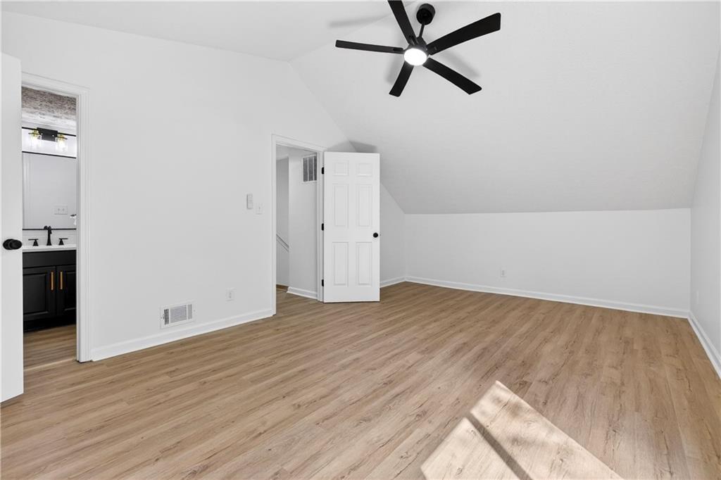 170 Kipling Way Riverdale, GA 30274 - Photo 12 of 16 an empty room with wooden floor and windows
