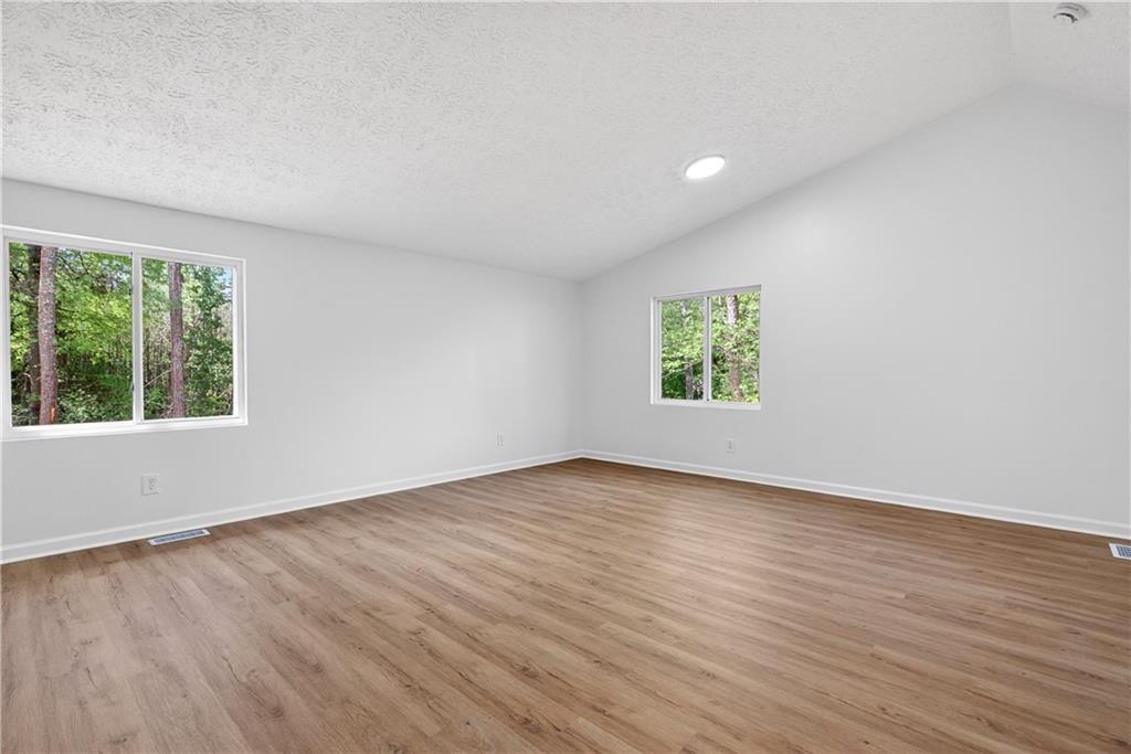 170 Kipling Way Riverdale, GA 30274 - Photo 13 of 16 a view of an empty room with wooden floor and a window
