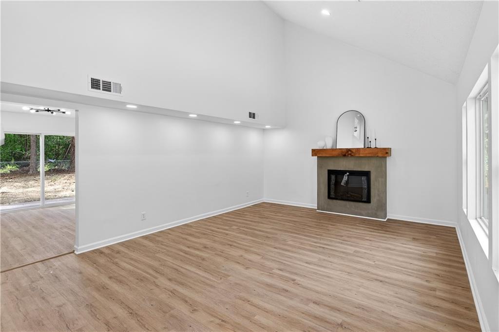 170 Kipling Way Riverdale, GA 30274 - Photo 2 of 16 a view of empty room with wooden floor and fireplace