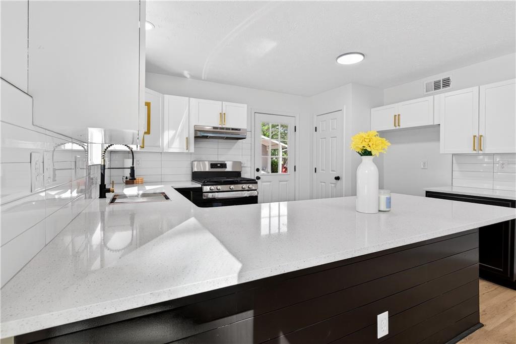 170 Kipling Way Riverdale, GA 30274 - Photo 5 of 16 a kitchen with kitchen island a sink counter top space and appliances