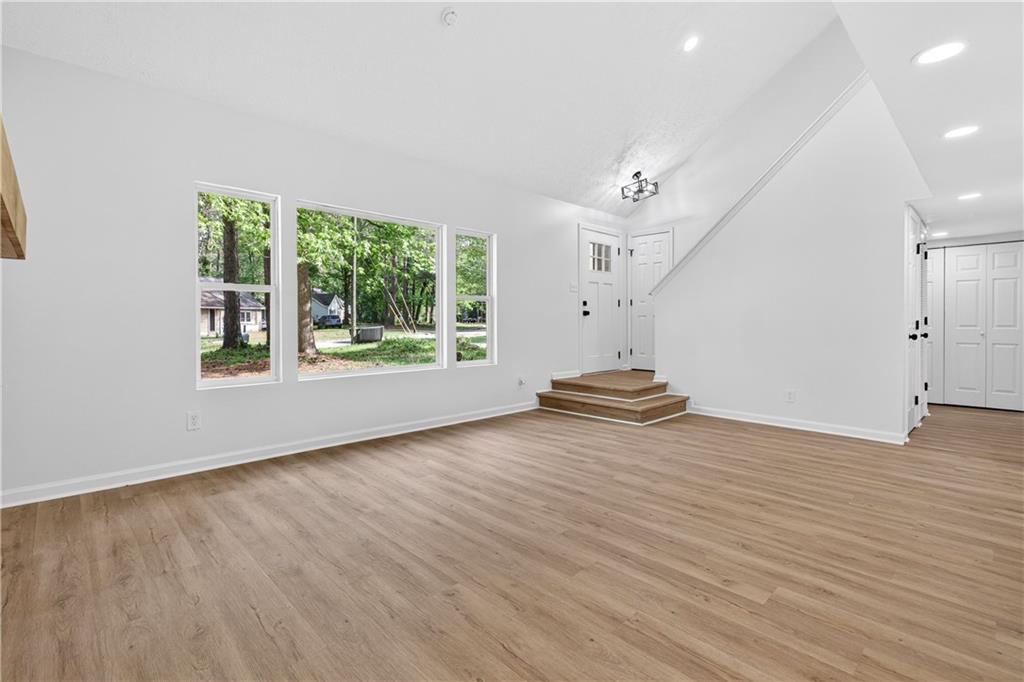 170 Kipling Way Riverdale, GA 30274 - Photo 6 of 16 an empty room with wooden floor and windows