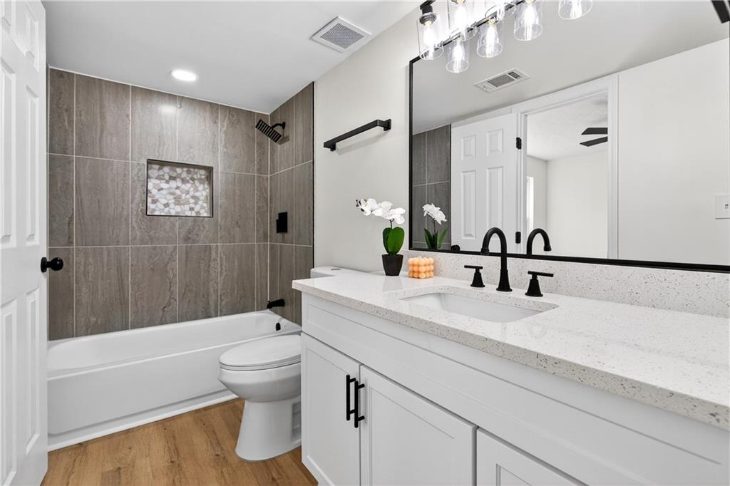 170 Kipling Way Riverdale, GA 30274 - Photo 7 of 16 a bathroom with a bathtub shower sink mirror and toilet