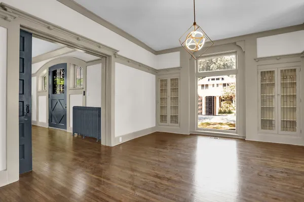 a view of an entryway with wooden floor and door