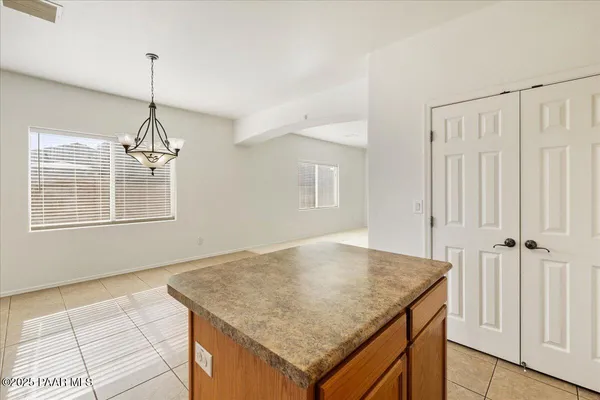 an empty room with a window and a ceiling fan