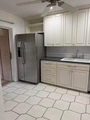 a kitchen with a sink and a stove top oven