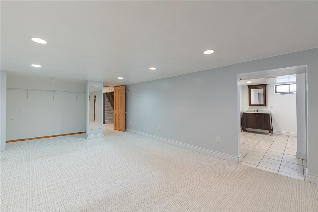 5235 West Ridgewood Road Springfield, OH 45503 - Photo 24 of 32 The bright lower level provides flexible living space, seamlessly connecting to a stylish bathroom area.