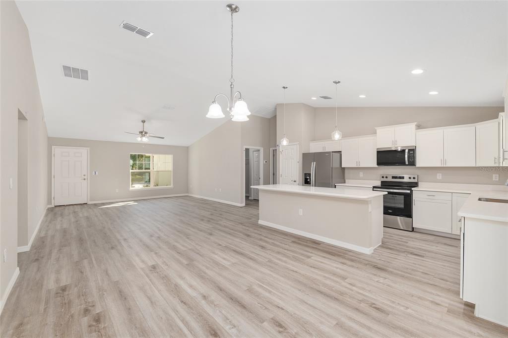 21010 Southwest 102nd Street Road Dunnellon, FL 34431 - Photo 12 of 47 a view of kitchen with kitchen island sink microwave and refrigerator