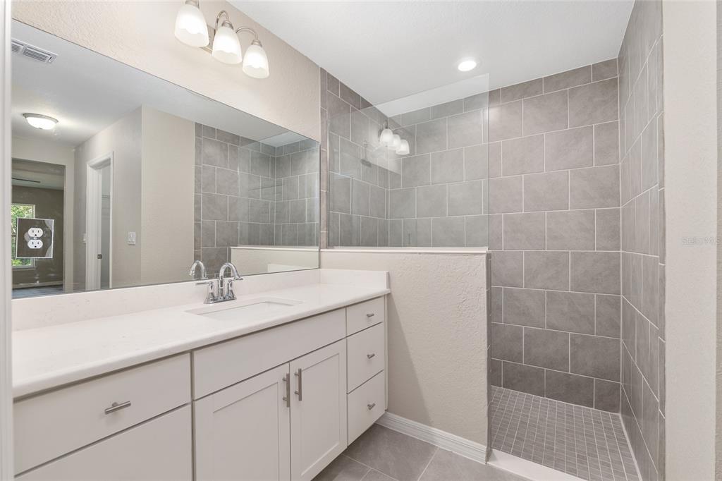 21010 Southwest 102nd Street Road Dunnellon, FL 34431 - Photo 17 of 47 a bathroom with a double vanity sink and a mirror