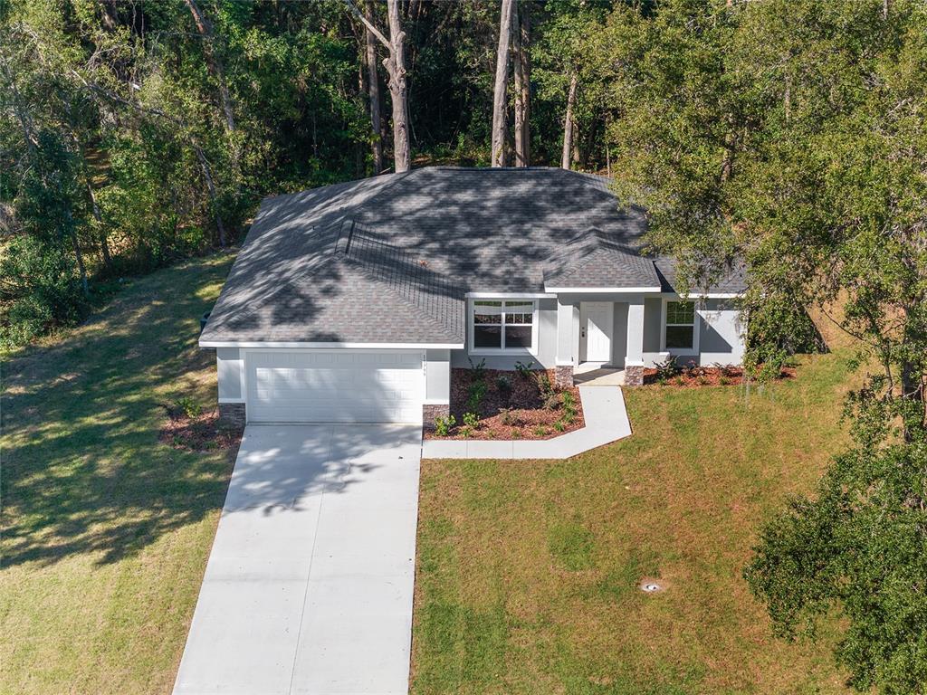 21010 Southwest 102nd Street Road Dunnellon, FL 34431 - Photo 2 of 47 a front view of a house with a yard