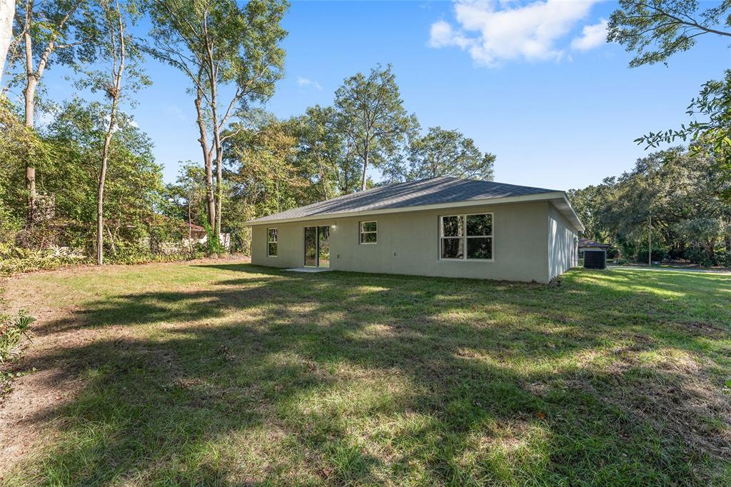 21010 Southwest 102nd Street Road Dunnellon, FL 34431 - Photo 32 of 47 a view of a house with a backyard
