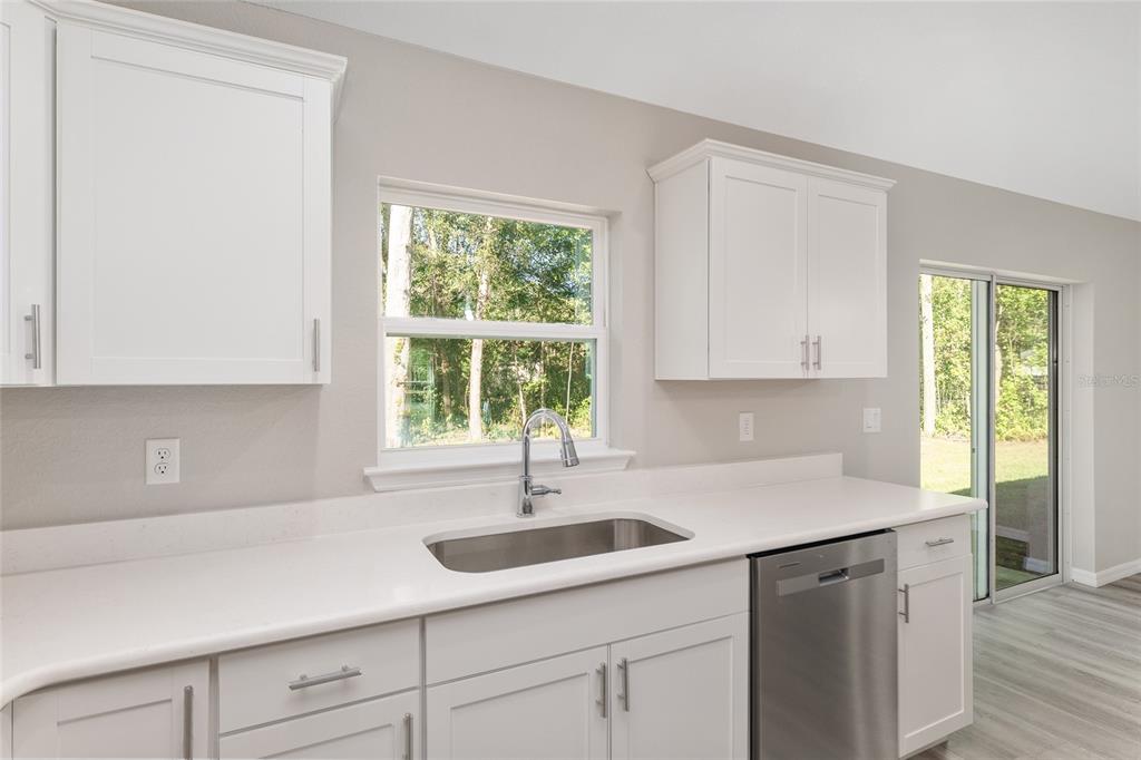 21010 Southwest 102nd Street Road Dunnellon, FL 34431 - Photo 8 of 47 a kitchen with a sink cabinets and window