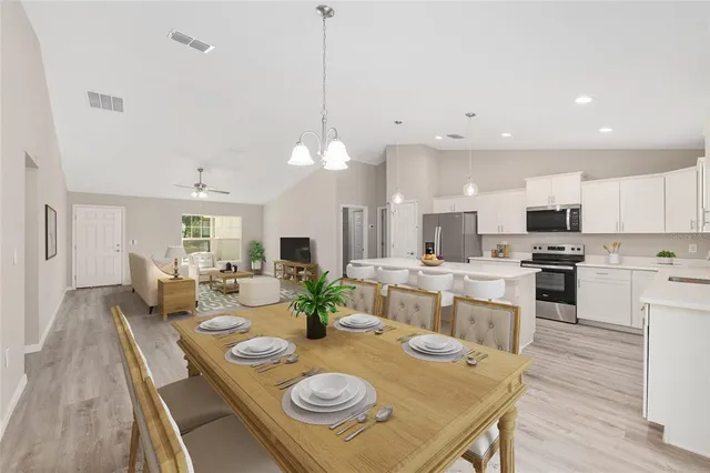 a open dining room with stainless steel appliances furniture stove and kitchen view